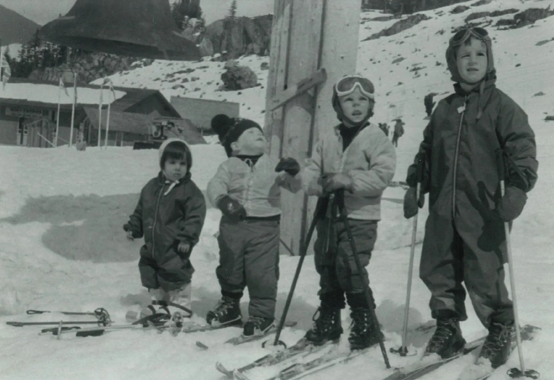 Four young children on skis at the base of a Whistler lift in the early 1970s